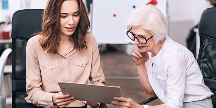 A younger and an older businesswoman discuss the project A younger and an older businesswoman discuss the project